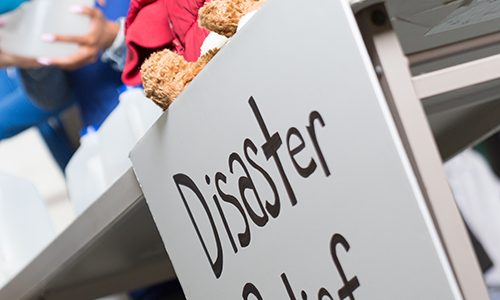 Closeup of a Disaster Relief sign at a center handing out water.